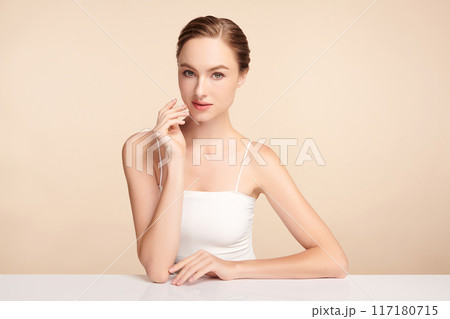 Beautiful young woman with clean fresh skin on beige background, Face care, Facial treatment, Cosmetology, beauty and spa, women portrait. 117180715