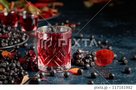 Black chokeberry juice and fresh berries. Black chokeberry juice and fresh berries. 117181982