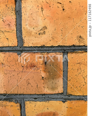 Red brick wall with black joints. Close up. 117182498