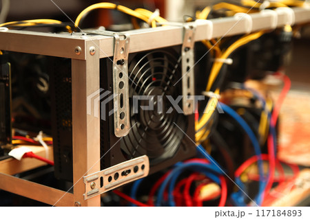 Close-up of computer hard drive, hard disk drive in a cooler. spare computer parts, internal components of a hard disk. Blurred. Mining farm 117184893