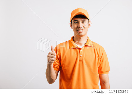 Portrait professional attractive delivery happy man standing he smile wearing orange t-shirt and cap uniform showing thumb up gesture looking to camera, studio shot isolated on white background 117185845