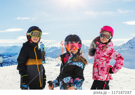 Three confident adorable teen kid friends portrait enjoy have fun skiing enjoy winter extreme sport activities on sunny day. Children winter sport camp school holidays. Healthy people lifestyle Three confident adorable teen kid friends portrait enjoy have fun skiing enjoy winter extreme sport activities on sunny day. Children winter sport camp school holidays. Healthy people lifestyle 117187287