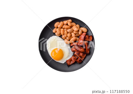 English breakfast with fried eggs, bacon, beans, tomatoes, spices and herbs English breakfast with fried eggs, bacon, beans, tomatoes, spices and herbs 117188550