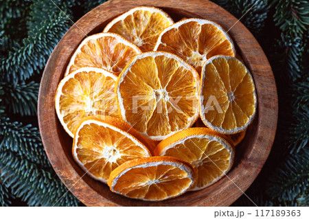 Top view of dried orange slices in wooden box 117189363