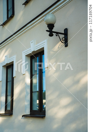 Vintage street lamp at the window of an old building Vintage street lamp at the window of an old building 117189704