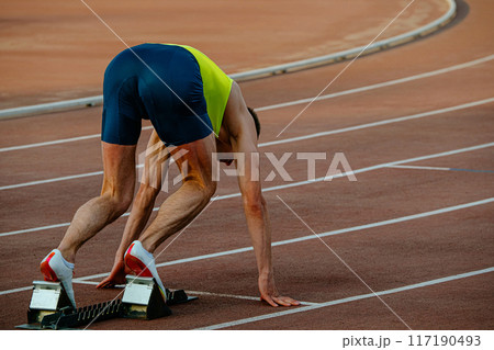 male runner in starting blocks sprint race 117190493