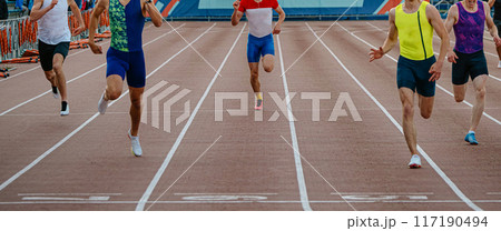 finish line sprint race in stadium, group athletes running together finish line sprint race in stadium, group athletes running together 117190494