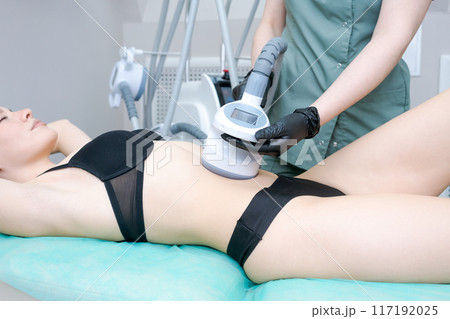 A woman is getting a body contouring treatment 117192025