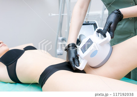 A woman is getting a leg waxed 117192038