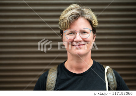 Portrait of a 38 yo white woman standing against a striped wall, Brussels, Belgium Portrait of a 38 yo white woman standing against a striped wall, Brussels, Belgium 117192066