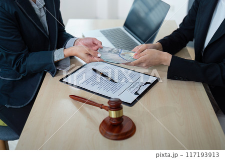 Lawyer Accepting Bribe Money in Office. Corruption and Bribery Concept with Legal Documents and Gavel Lawyer Accepting Bribe Money in Office. Corruption and Bribery Concept with Legal Documents and Gavel 117193913