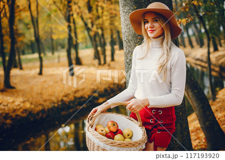 Beautiful woman in a park. Stylish girl in a brown hat Beautiful woman in a park. Stylish girl in a brown hat 117193920