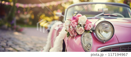 Pink wedding car adorned with floral bouquet 117194967