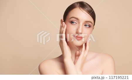 Beautiful young woman with clean fresh skin on beige background, Face care, Facial treatment, Cosmetology, beauty and spa, women portrait. Beautiful young woman with clean fresh skin on beige background, Face care, Facial treatment, Cosmetology, beauty and spa, women portrait. 117195221