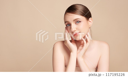 Beautiful young woman with clean fresh skin on beige background, Face care, Facial treatment, Cosmetology, beauty and spa, women portrait. 117195226