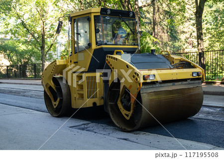 Roller for laying fresh hot asphalt on the road. Road construction equipment.  117195508