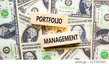 Portfolio management symbol. Concept words Portfolio management on beautiful wooden block. Beautiful dollar bills background. Dollar bills. Business Portfolio management concept. Copy space. 117197422