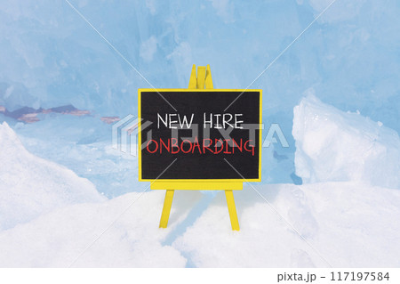 New hire onboarding symbol. Concept words New hire onboarding on beautiful yellow black blackboard. Beautiful blue ice background. Business new hire onboarding concept. Copy space. 117197584