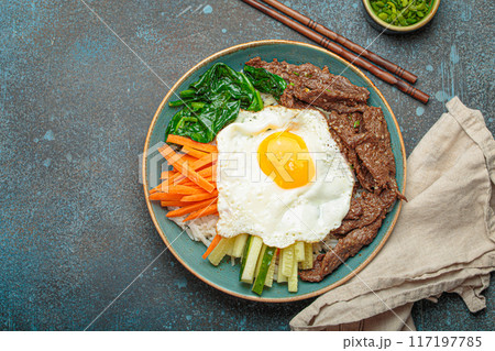 Traditional korean dish bibimbap with fried egg on top, top view with copy space 117197785