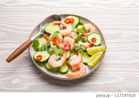 Delicious shrimp salad with cucumbers, lime, and cilantro on a plate 117197820