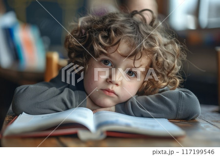 Desperate teenage pupil sitting at the library table with big stacks of books 117199546