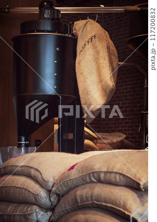 Coffee Roasting Equipment and Burlap Bags full of coffee beans in Coffee Shop 117200832