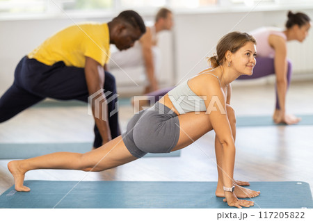 Body arching exercises during pilates workout for multinational group athletes Body arching exercises during pilates workout for multinational group athletes 117205822