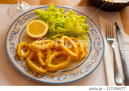 Crispy squid rings in batter Roman style. Traditional spanish dish Crispy squid rings in batter Roman style. Traditional spanish dish 117206077