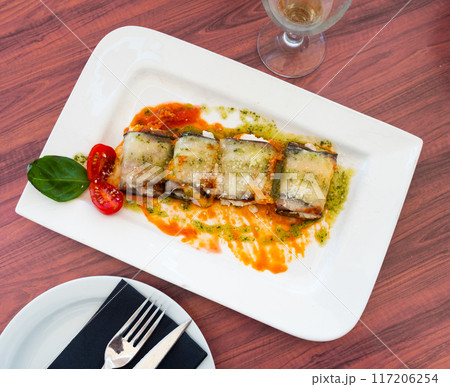 Stuffed eggplants with sauce served on platter 117206254