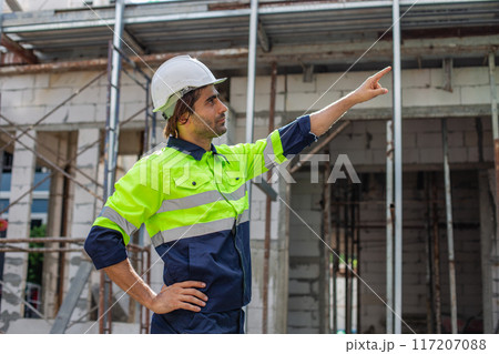 portrait of man engineer builder house construction wear white helmet and safety uniform.  117207088