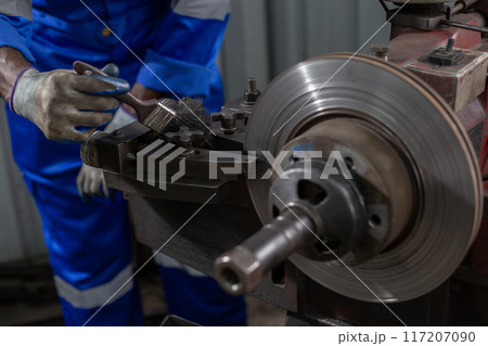 Engineering worker cleaning working machine lathe metal Engineering worker cleaning working machine lathe metal 117207090