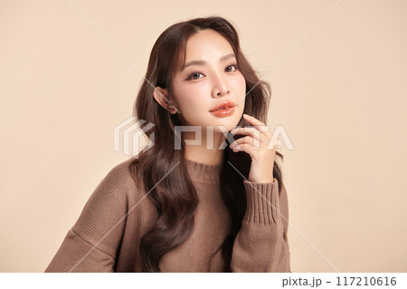 Beautiful young asian woman with clean fresh skin on beige background, Face care, Facial treatment, Cosmetology, beauty and spa, Asian women portrait. Beautiful young asian woman with clean fresh skin on beige background, Face care, Facial treatment, Cosmetology, beauty and spa, Asian women portrait. 117210616