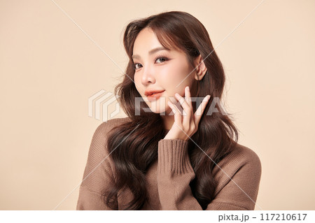 Beautiful young asian woman with clean fresh skin on beige background, Face care, Facial treatment, Cosmetology, beauty and spa, Asian women portrait. Beautiful young asian woman with clean fresh skin on beige background, Face care, Facial treatment, Cosmetology, beauty and spa, Asian women portrait. 117210617