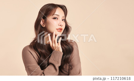 Beautiful young asian woman with clean fresh skin on beige background, Face care, Facial treatment, Cosmetology, beauty and spa, Asian women portrait. Beautiful young asian woman with clean fresh skin on beige background, Face care, Facial treatment, Cosmetology, beauty and spa, Asian women portrait. 117210618
