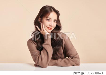 Beautiful young asian woman with clean fresh skin on beige background, Face care, Facial treatment, Cosmetology, beauty and spa, Asian women portrait. 117210621