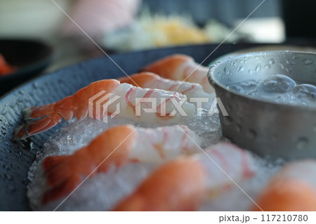 Raw fresh shrimps on ice in a restaurant 117210780