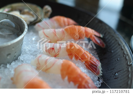 Raw fresh shrimps on ice in a restaurant Raw fresh shrimps on ice in a restaurant 117210781