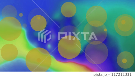 Image of yellow light spots over colourful shapes on blue background 117211331