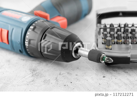 Professional cordless drill screwdriver and screwdriver bit set close-up Professional cordless drill screwdriver and screwdriver bit set close-up 117212271