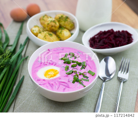 Cold pink beetroot soup with cucumber, boiled egg, dill and yogurt in white bowl lithuanian Cold pink beetroot soup with cucumber, boiled egg, dill and yogurt in white bowl lithuanian 117214842