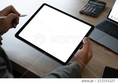 hands of a man holding blank tablet a mockup. iPad digital tablet workspace table hands of a man holding blank tablet a mockup. iPad digital tablet workspace table 117215127