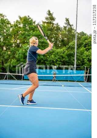Professional tennis players playing the tennis on outside court Professional tennis players playing the tennis on outside court 117217238