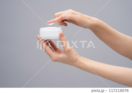 Close up of females hands with a jar of face cream 117218076