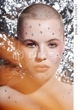 Vertical portrait of confident young woman with buzzcut wearing creative make up on metallic background Vertical portrait of confident young woman with buzzcut wearing creative make up on metallic background 117219247