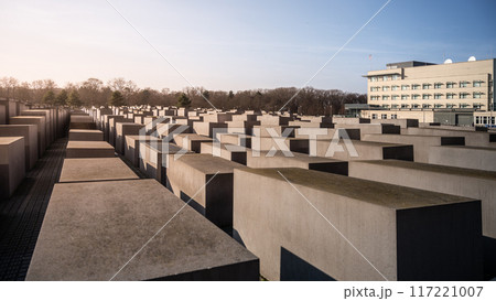 Rows of concrete slabs forming the Holocaust Memorial under clear skies in Berlin, Germany Rows of concrete slabs forming the Holocaust Memorial under clear skies in Berlin, Germany 117221007