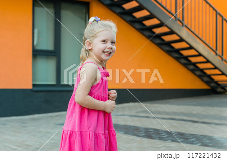 Child with hearing problem and cochlear implant plays in street, deaf kid began to hear. Hearing loss in childhood and treatment concept. Inclusion and disability. Copy space and empty place for text. Child with hearing problem and cochlear implant plays in street, deaf kid began to hear. Hearing loss in childhood and treatment concept. Inclusion and disability. Copy space and empty place for text. 117221432