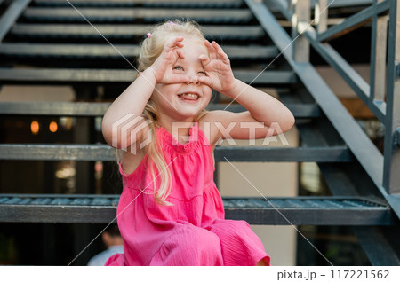 Funny baby with cochlear implant walks outdoor. Hearing aid and medicine innovating technology concept. Diversity and Inclusion and people with disability concept. 117221562