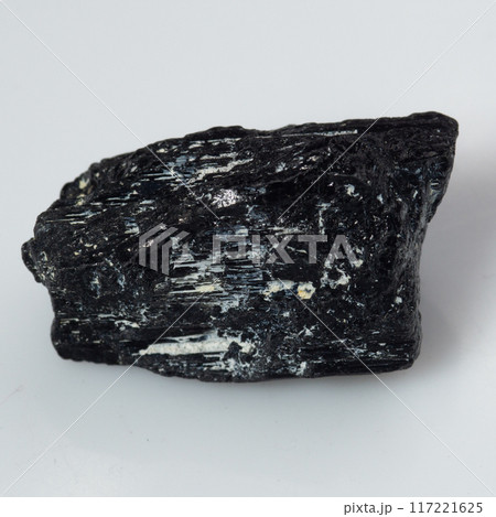 natural black tourmaline scherl on the white background natural black tourmaline scherl on the white background 117221625