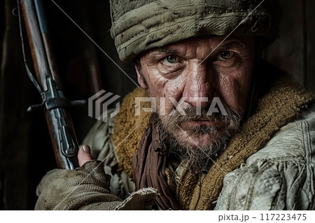 A fierce Cossack warrior stands poised, gripping his rifle tightly, exuding determination amidst an ancient backdrop. His weathered features reflect strength and resilience. 117223475