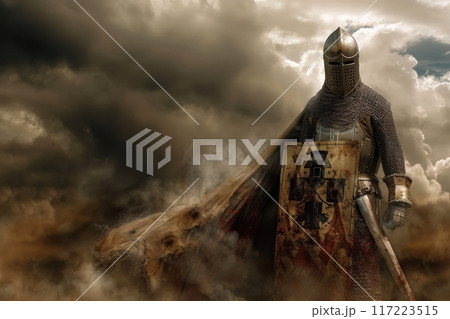 A valiant crusader clad in chainmail and armor holds a weathered sword and shield, standing defiantly against a backdrop of tumultuous clouds at dusk. 117223515